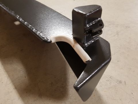 1978 Ford Bronco - Metal bracket with a white plastic tube, likely a vehicle part. Supermotors logo is present.