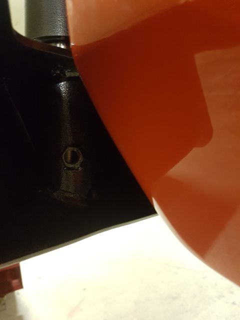 1978 Ford Bronco - Close-up of a black metal component with an orange plastic container pouring liquid onto it, a Supermotors.net watermark.
