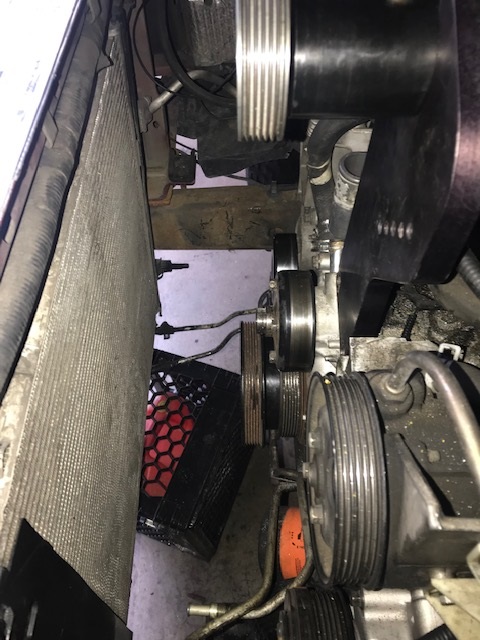 2000 Ford Explorer - Engine bay view showing belt tensioner, pulleys, and radiator assembly.