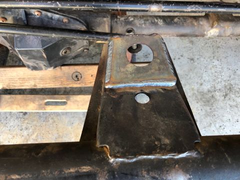1992 Jeep Wrangler - Close-up of a welded bracket on a vehicle frame, showing a circular mounting hole.