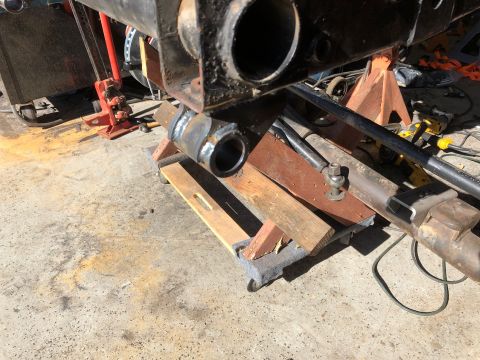 1992 Jeep Wrangler - Close-up of vehicle suspension parts, possibly undergoing repair or modification.