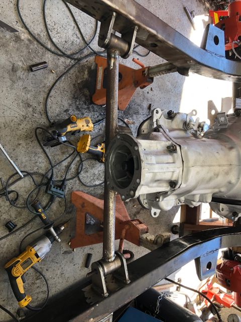 1992 Jeep Wrangler - Vehicle drivetrain components are shown disassembled on jack stands with various tools nearby.