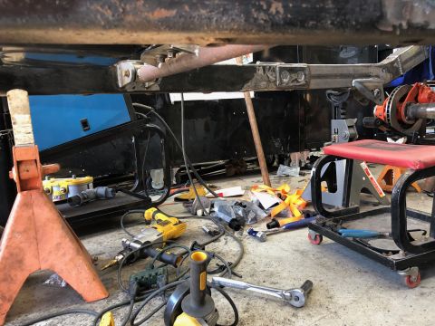 1992 Jeep Wrangler - A view of a vehicle's undercarriage and drivetrain components, surrounded by various tools.