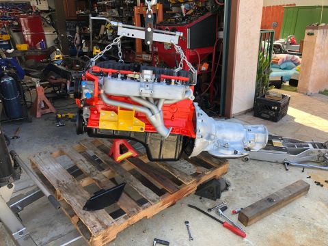 1992 Jeep Wrangler - Engine and transmission assembly being worked on in a garage setting.