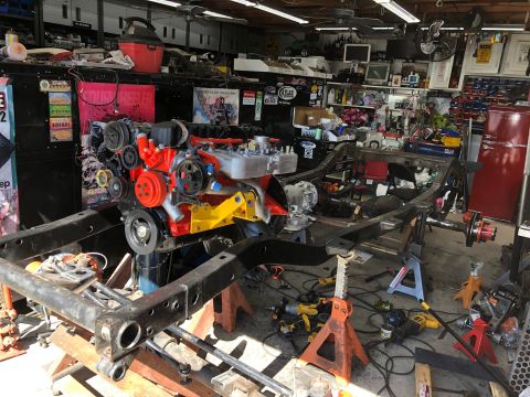 1992 Jeep Wrangler - Engine and frame assembly for a 1992 Jeep Wrangler in a garage workshop.