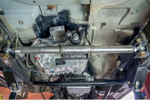 1992 Jeep Wrangler - The undercarriage of a vehicle displays its transmission and suspension system, with visible branding on the transmission casing.