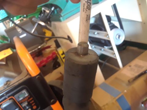 1996 Ford F-350 - A shock absorber is marked with a fine point marker in a workshop setting.