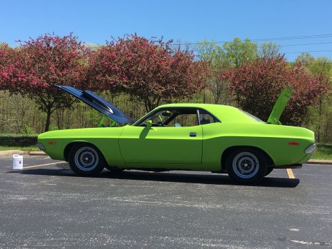 1974 Dodge Challenger - A bright green classic coupe sits in a parking lot with its hood and trunk open, surrounded by trees.