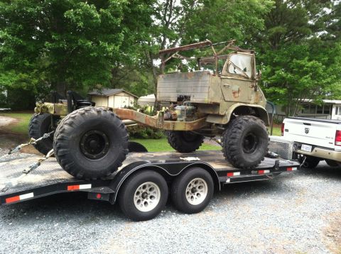 2009 Harley-Davidson FLH - This olive green military truck, possibly a Pinzgauer, is being transported on a trailer, showing its off-road capabilities.