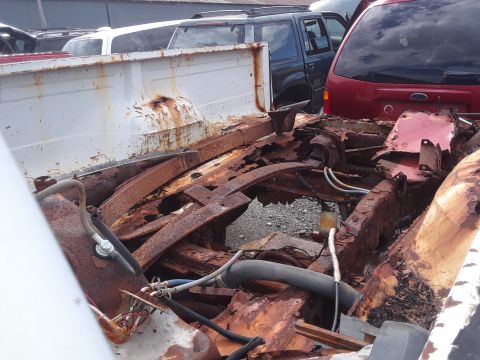 1994 Ford Bronco - This vehicle's frame and bed are severely rusted, indicating significant disrepair.