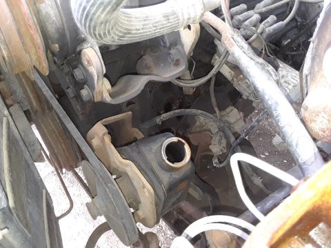 1994 Ford Bronco - Close-up view of an engine bay, focusing on the power steering reservoir and surrounding components.