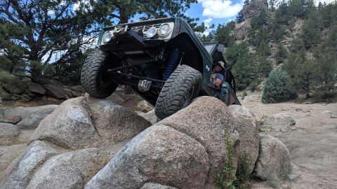 1995 Ford Bronco - This modified Ford Bronco navigates a challenging rocky terrain, its off-road capabilities.