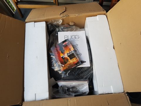 1978 Ford Bronco - Barbecue grill components and manuals are seen inside a shipping box.