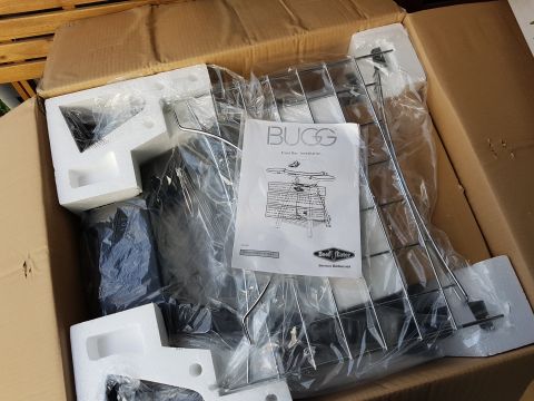 1978 Ford Bronco - Unassembled BBQ grill components are packed in a box with a 'BUGG' installation manual.