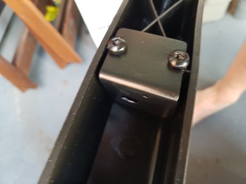 1978 Ford Bronco - Close-up of a metal bracket assembly within a black housing.