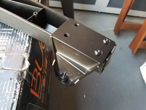 1978 Ford Bronco - A close-up view of a metal bracket and plastic part, with visible screws.