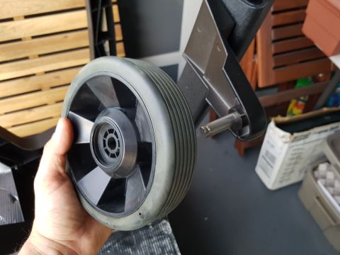 1978 Ford Bronco - Close-up of a wheel and its mounting bracket, likely a replacement part.