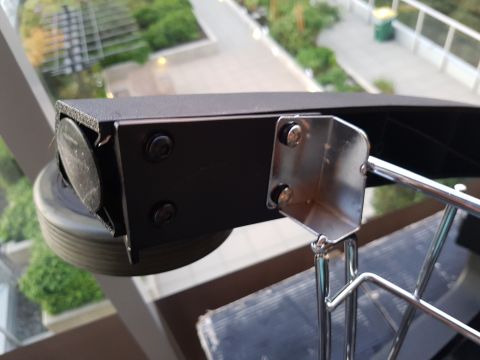 1978 Ford Bronco - A close-up view shows a black metal bracket with a wheel, likely part of a larger rack system.