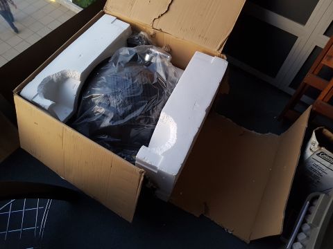 1978 Ford Bronco - A car part is packaged in a cardboard box with styrofoam inserts.
