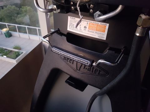 1978 Ford Bronco - A warning label is attached to a metal handle on a barbecue grill.