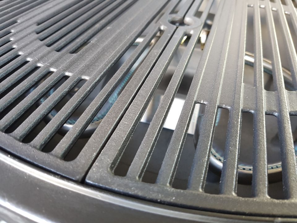 Close-up of cast iron grill grates over a burner
