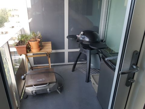 1978 Ford Bronco - Balcony scene with two grills and potted plants, overlooking an urban area.
