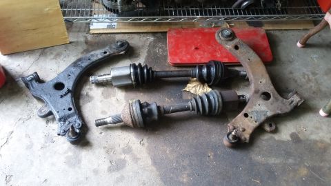 Control arms and CV axles on concrete floor