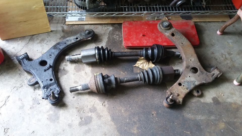 Control arms and CV axles on concrete floor
