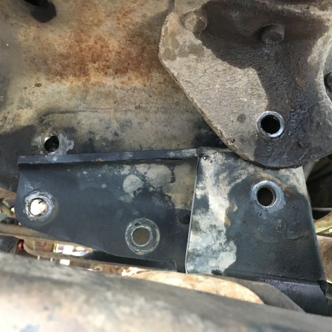 1996 Ford Bronco - Detail of a corroded metal bracket, likely from a vehicle's undercarriage.