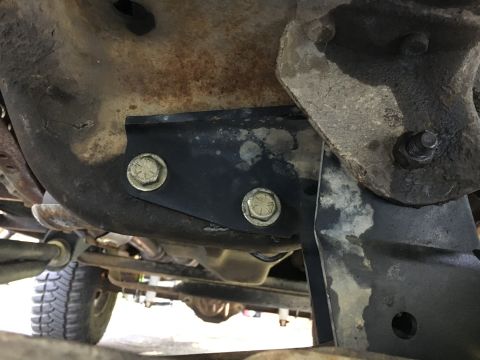 1996 Ford Bronco - Undercarriage view shows a bolted metal bracket attached to a rusty component.