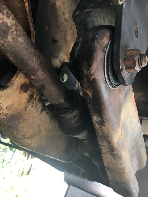 1996 Ford Bronco - Underside view of rusty suspension parts, including a sway bar link and bushing, with a Supermotors.net watermark.