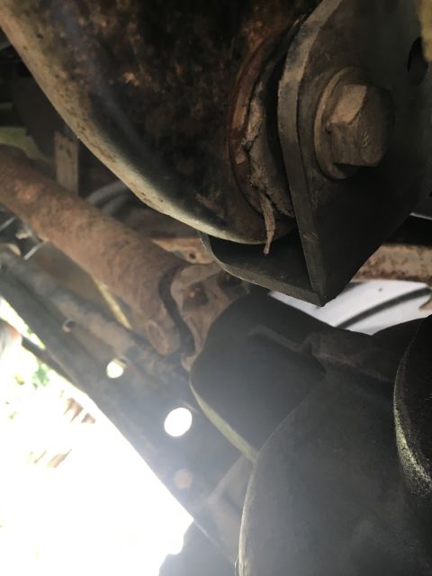 1996 Ford Bronco - Underside view of a vehicle's driveshaft and suspension components, showing rust and wear.