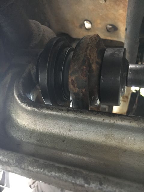 1996 Ford Bronco - A detailed view of a worn suspension component, showing rust and rubber elements.