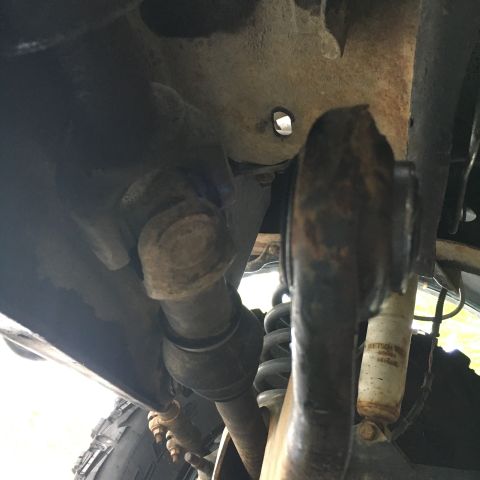 1996 Ford Bronco - Close-up view of the suspension system on a 1996 Ford Bronco, showing various mechanical parts.