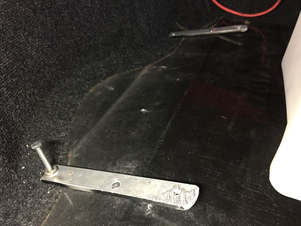 Interior floor with metal brackets and bolts, Supermotors logo visible
