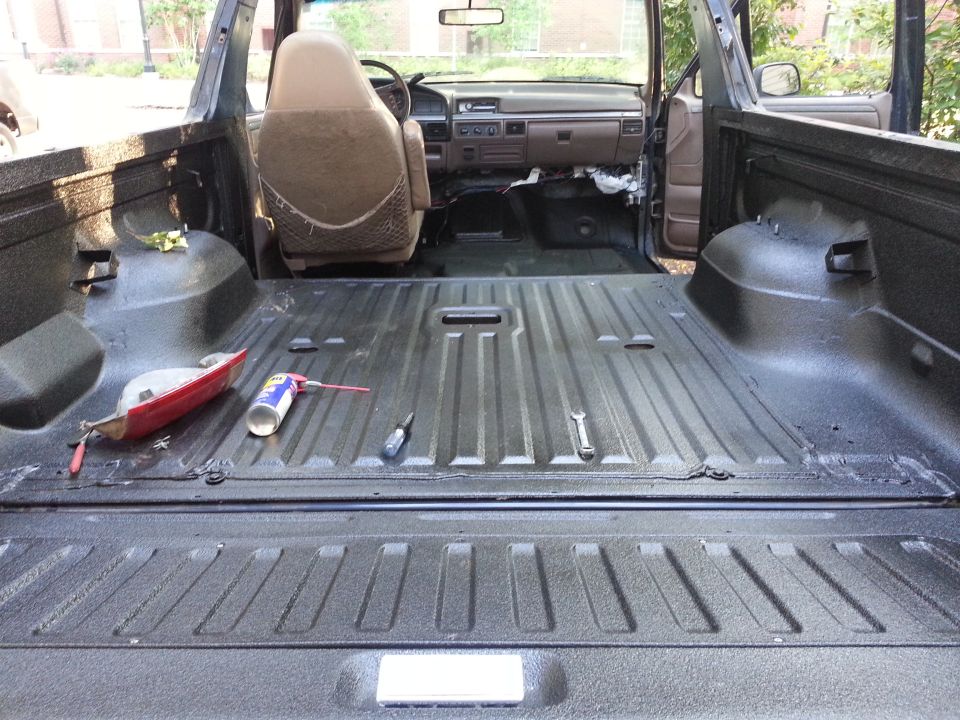 Interior of a 1995 Ford Bronco with spray-in bed liner and exposed cabin