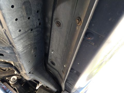 2018 Toyota 4Runner - The underbody of a vehicle reveals mounting points for running boards, but no specific year or model is identifiable.