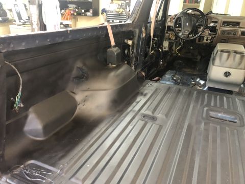 1995 Ford Bronco - Interior of a 1995 Ford Bronco undergoing a redo, with seats and panels removed.