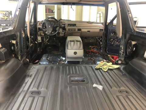 1995 Ford Bronco - The interior of a 1992 Ford Bronco is shown with its components removed for refurbishment.