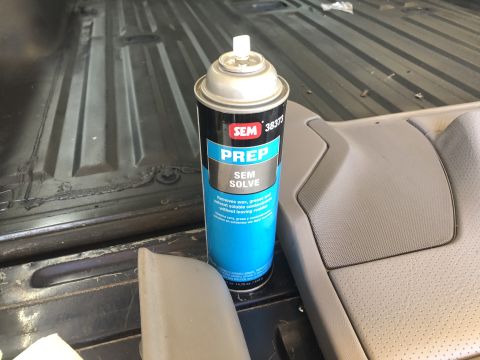 1995 Ford Bronco - A can of SEM Solve is placed on the floor of a vehicle, near interior trim pieces.