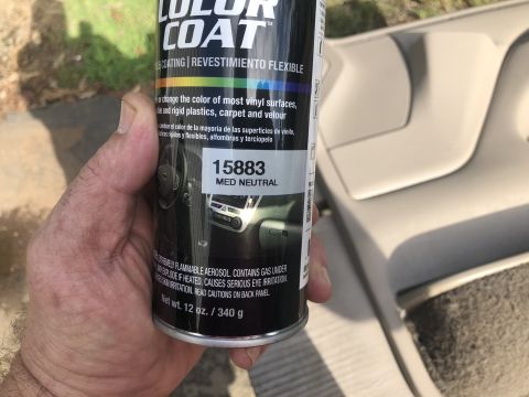 1995 Ford Bronco - A can of spray paint is held up against a car's interior panel, showing the color "Med Neutral".
