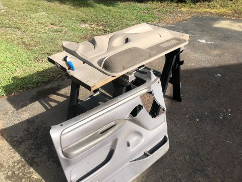 1995 Ford Bronco - Interior door panels are disassembled and laid out on sawhorses for refurbishment.