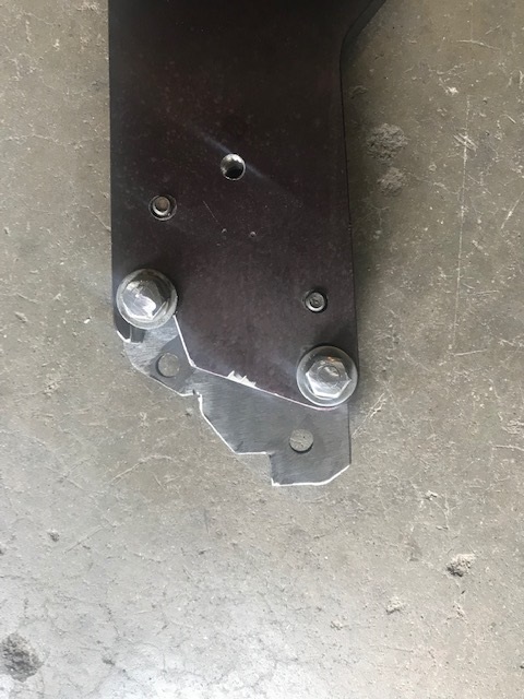 2000 Ford Explorer - Metal bracket with bolts and screws on concrete floor.