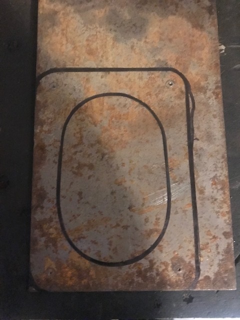 2000 Ford Explorer - Metal plate with a drawn outline, possibly for a template or part.