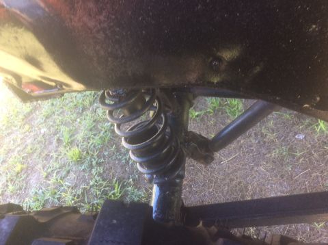 1992 Ford Bronco - Undercarriage view shows a coil spring and suspension linkage.