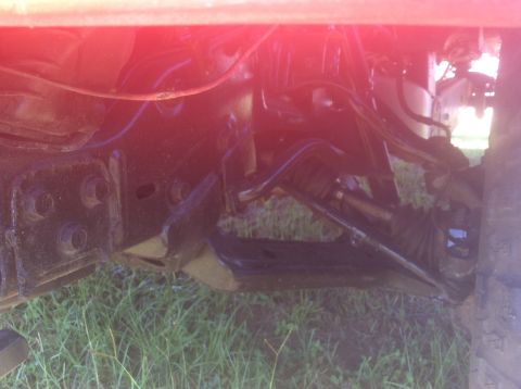 1992 Ford Bronco - Close-up view of a vehicle's undercarriage, showing mechanical parts and frame.