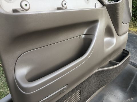 1995 Ford Bronco - Interior door panel storage compartments and textured trim, consistent with a 1995 Ford Bronco.