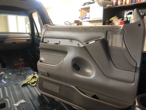 1995 Ford Bronco - The interior door panel of a Ford Bronco, likely from the early to mid-1990s, is shown during a refurbishment process.
