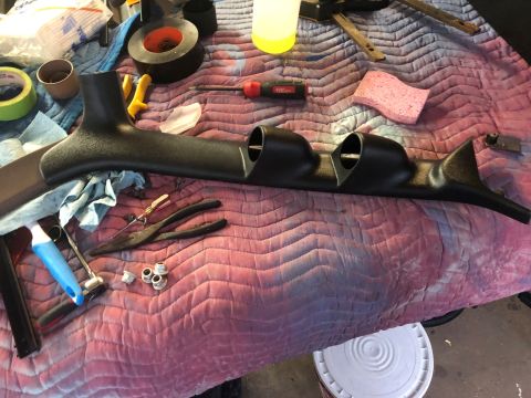 1995 Ford Bronco - A black triple gauge pod and various tools are laid out on a pink quilted mat, ready for installation.
