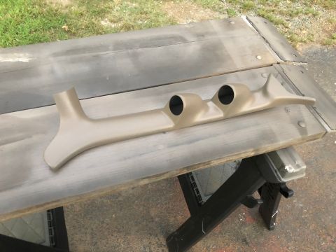1995 Ford Bronco - A tan dashboard gauge pod with two openings is shown, likely for aftermarket gauges.